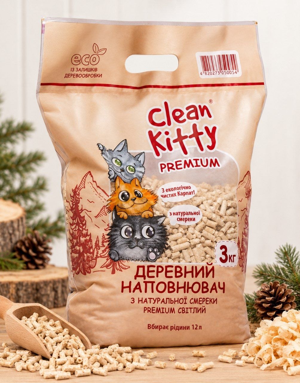 Sacco Clean Kitty PREMIUM da 3 kg con granuli di abete bianco sparsi e una paletta di legno