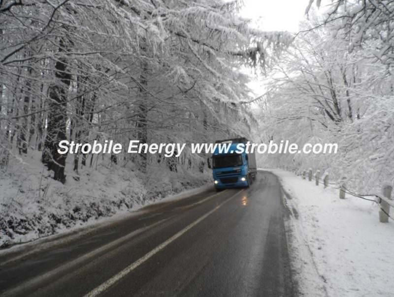 A truck of Virgin Wood Pellets Silver Fir is rushing through a winter forests of Bukovina to retail consumers